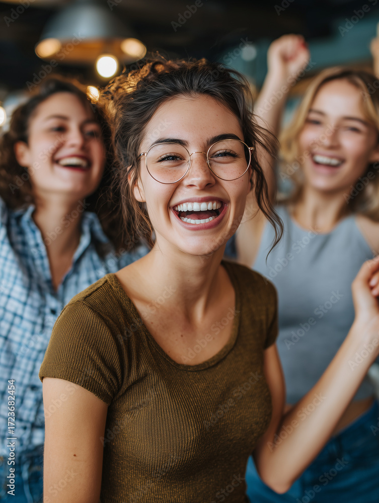 Fototapeta premium Young women friends laughing at a party