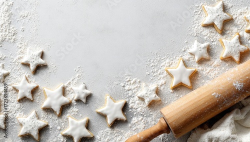 Baking festive star shaped cookies with flour and rolling pin.