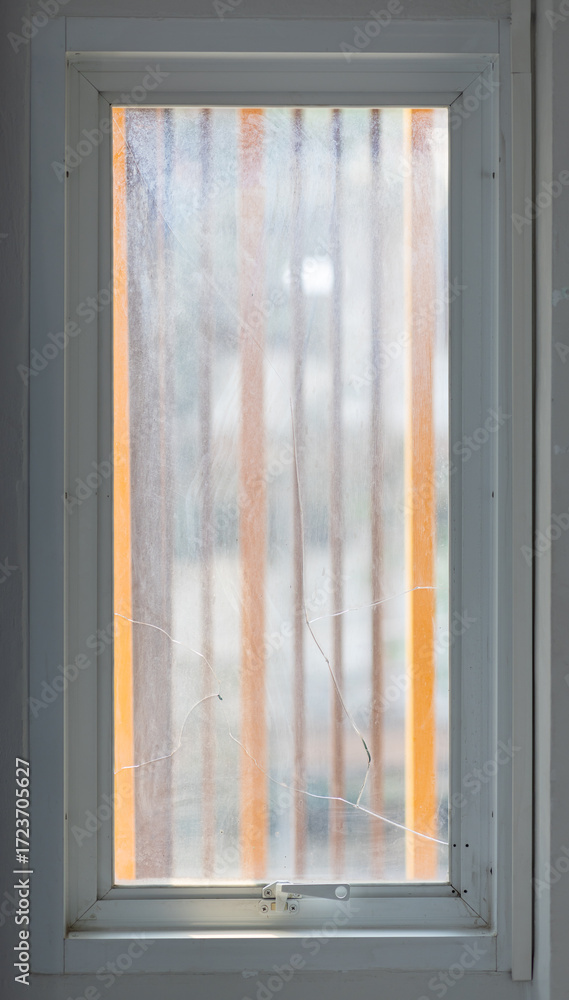 Fototapeta premium Window pane with broken and cracked glass.