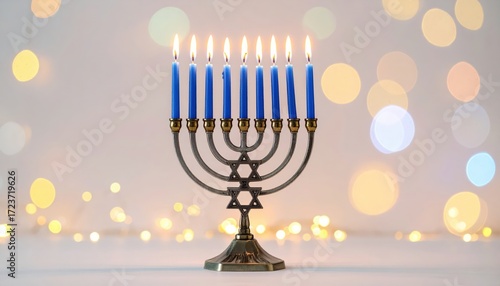 A Menorah with nine lit blue candles stands against a soft, bokeh background of warm, glowing lights, symbolizing Hanukkah.