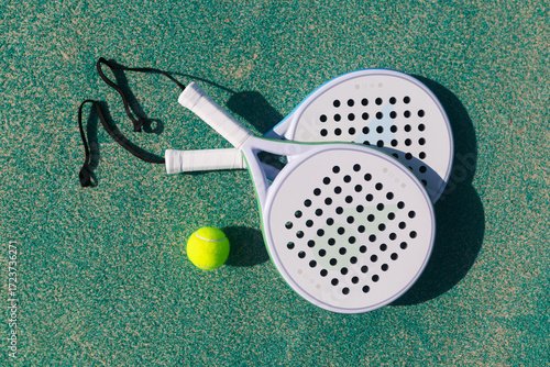 Padel racket and ball on the tennis court. Top view.