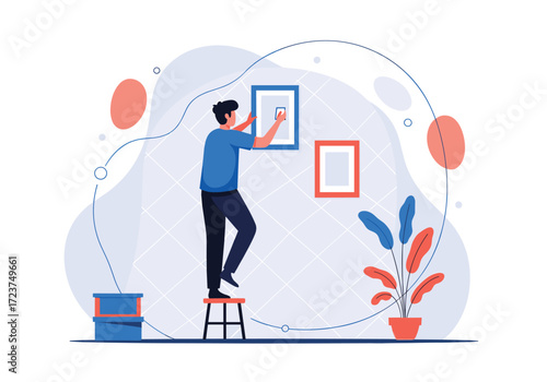 Man hanging pictures on wall a new home.