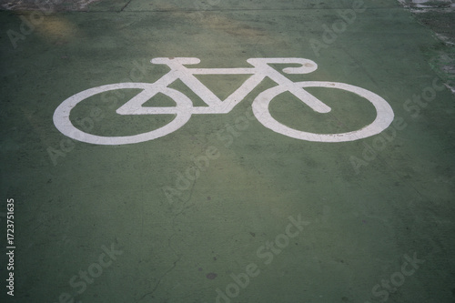 Bicycle lane symbol on the green concrete way