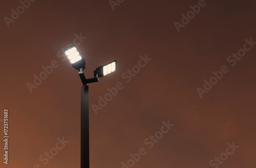 Double luminaire LED street light in the dusk