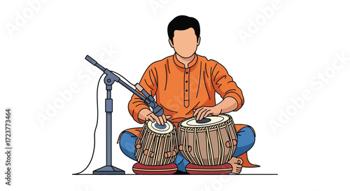 A man playing tabla drums in a recording studio setup.
