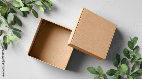 wooden box with green leaves on wooden background