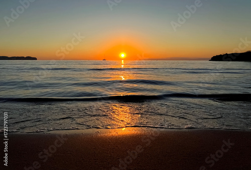 Sunset at sea. The setting sun over the horizon. Photo