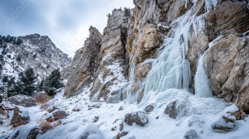 Wallpaper Mural Majestic winter mountain landscape with frozen waterfall, icy cliffs, snow covered rocks, crystal ice formations, seasonal cold wilderness scene Torontodigital.ca