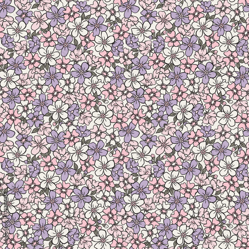 Dense ditsy floral seamless pattern. Pretty millefleur background with pink and lilac spring blossoms for romantic fabric, vintage-style wallpaper, and feminine apparel.