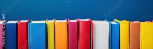 Colorful Books Lined up on a Shelf in an Organized Display for Easy Access an...