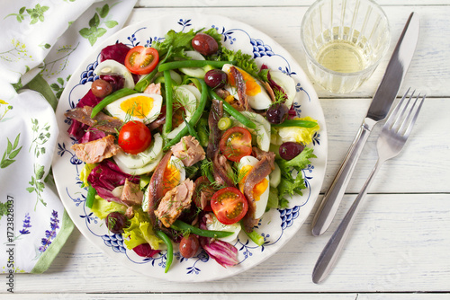 Mediterranean Tuna Salad. Nicoise Salad. White wooden background. High angle view