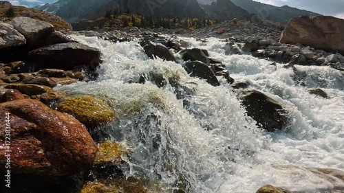 A swift mountain river surrounded by a rocky landscape