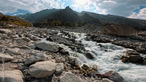 Fast mountain stream among rocks and cliffs