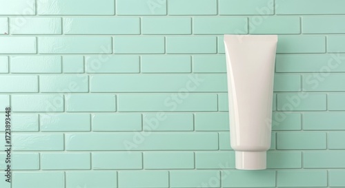 Wallpaper Mural Minimalist white cosmetic tube rests against a clean, pastel mint green tiled wall. Torontodigital.ca