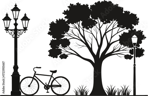 Silhouette of a bicycle under a large tree next to a lamp post
