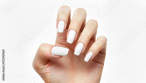 Manicure with white nail polish on woman’s hand against white background  