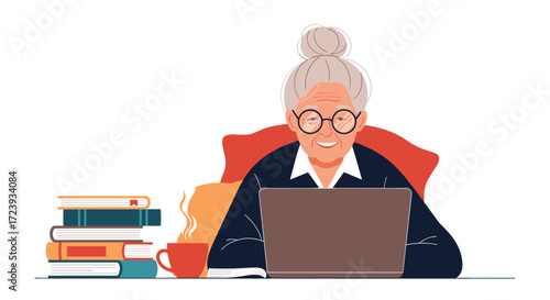 An experienced professional woman working on her laptop at a desk with books and coffee.
