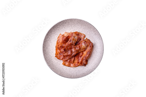 Fried pork bacon slices or strips as a breakfast ingredient. Fried bacon