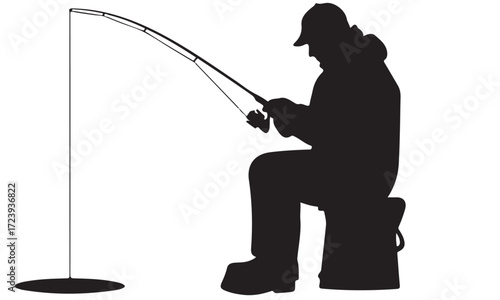 Black Silhouette of an Ice Angler Fishing on a Frozen Body of Water in Winter