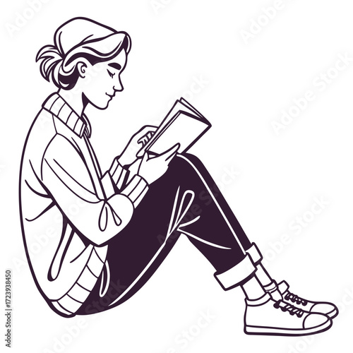 Young woman sitting cross legged reading a book in a casual outfit with a sweater and sneakers
