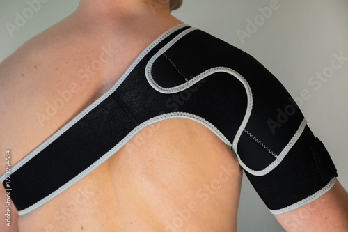 Shoulder joint brace for Rotator Cuff Recovery. Man in a support orthopedic bandage.