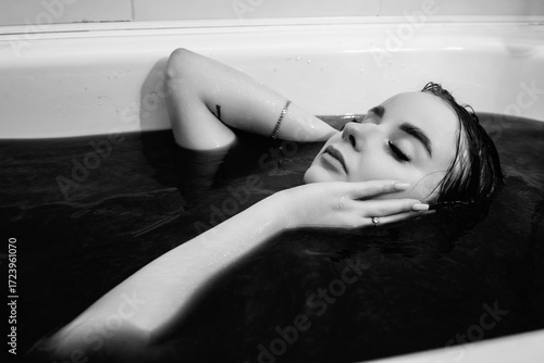 Photos Aesthetic portrait of a young beautiful dark-haired girl in the bath water