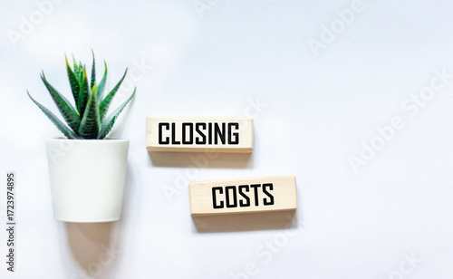 CLOSING COSTS - words on wooden blocks on a white background