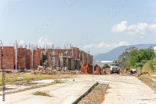Red brick house under construction, Construction workers, masons, bricklayers, masons, House under construction, Holy Cross Day, Guadalajara, Jalisco, Mexico, November 2, 2024. Infonavit, fovissste.