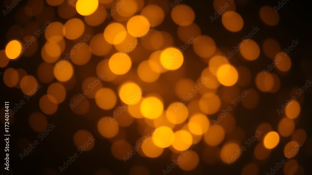 Fototapeta premium Dreamy golden bokeh sparkles on a dark background creating an atmospheric glowing effect.