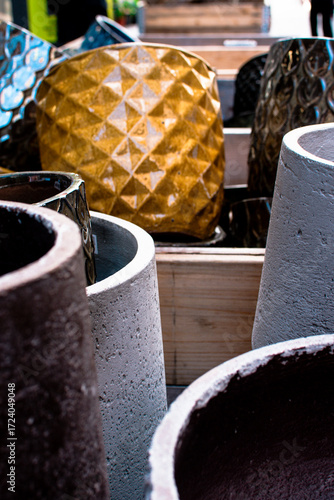Colorful pots on display in a market in Denmark showcasing unique designs and vibrant colors for gardening enthusiasts