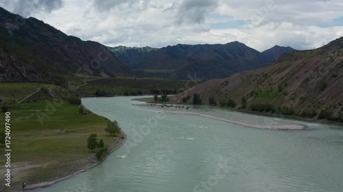 Aerial view of the mountain river between the mountains