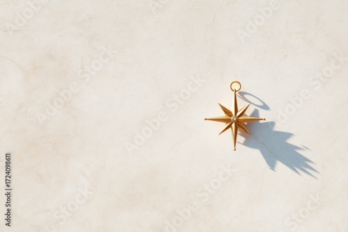 Golden compass resting on textured surface, casting delicate sha