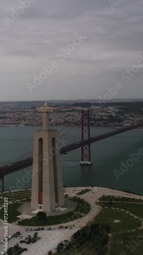 Aerial View of Christ King in Almada and 25 De Abril Bridge Over the Tejo River at Sunset in Lisbon Portugal