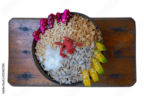 Colorful Granola Bowl With Dragon Fruit, Mango, Coconut, Seeds, and Goji on Wooden Board Platter