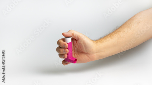 Hands holding asthma inhaler,Bronchodilator  for relief asthma attack on white background. Pharmaceutical products is used to prevent and treat wheezing and shortness of breath caused asthma or COPD.