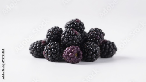 A pile of fresh blackberries on a white background