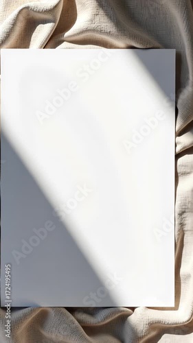 Illuminated Blank Canvas with Draped Fabric Background Highlighted by Sunlit Shadows Creating Dynamic Visual Interest in Minimalist Space