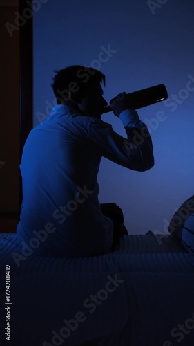 vertical video Man drinking alcohol alone struggling with addiction