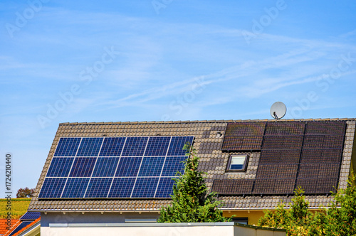 Solaranlagen auf Hausdächern vor blauem Himmel
