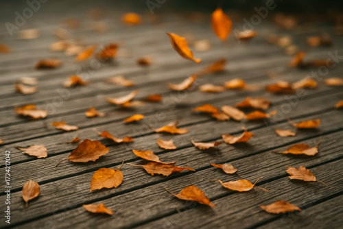 Shallow-focus wooden deck with small amber leaves drifting in breeze; peaceful fall moment. generative AI