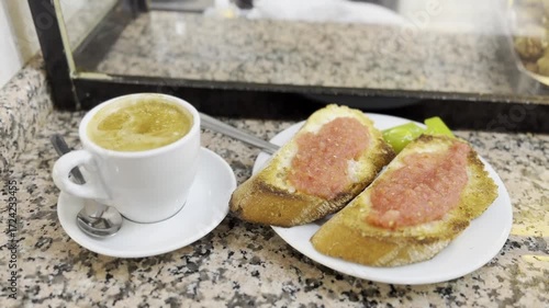 Traditional Spanish breakfast with café con leche and pan con tomate, served on a marble counter, showcasing authentic Mediterranean cuisine, rustic lifestyle, and European café culture.