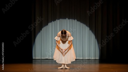A graceful ballet dancer taking a bow under the spotlight.