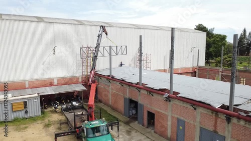 construction worker climbing scaffolding inside building under construction