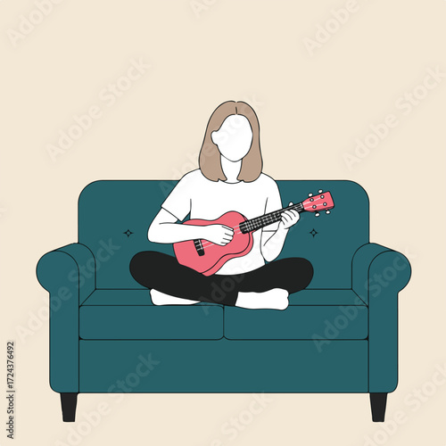 Faceless woman plays ukulele while sitting cross-legged on blue sofa