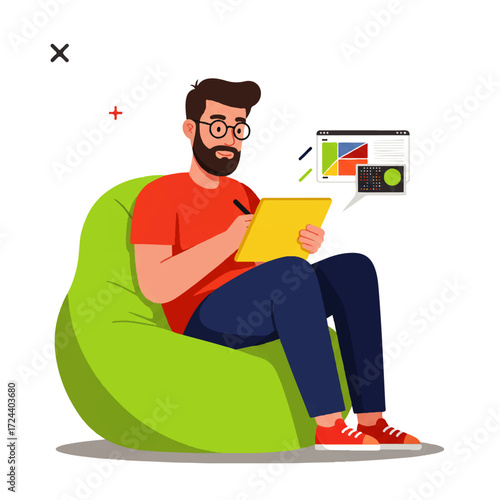 A bearded man with glasses sits in a green beanbag chair, drawing on a yellow tablet with a stylus, with a computer screen displaying design elements.