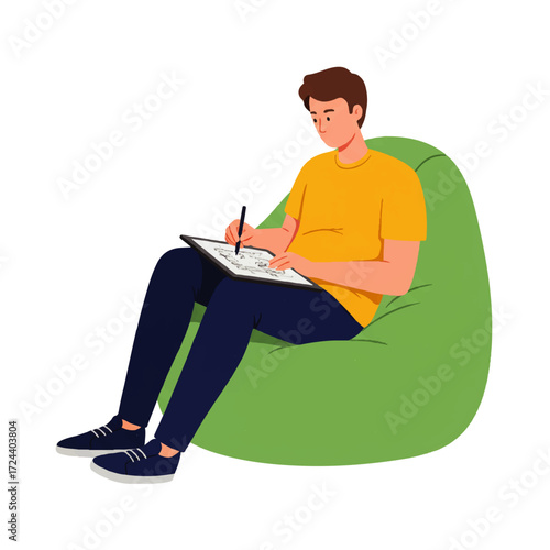 A young man sits comfortably in a green beanbag chair, drawing on a digital tablet with a stylus.