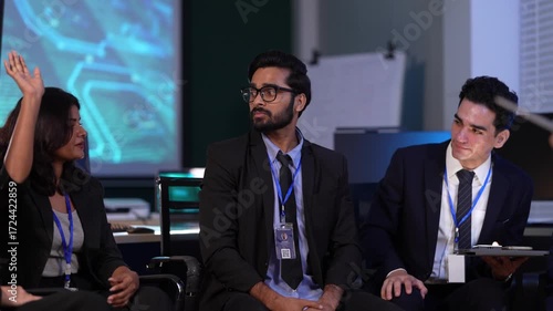 In a corporate war room, a strategy team interacts with an immersive AI driven simulation on a holographic display, wargaming market scenarios and making data backed decisions.