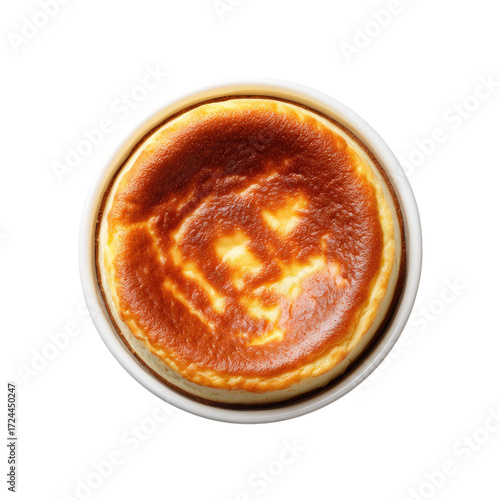 Top-down view of a small, baked cheesecake in a white dish