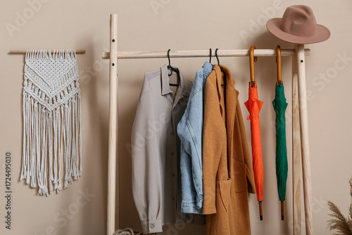 Rack with autumn clothes in...