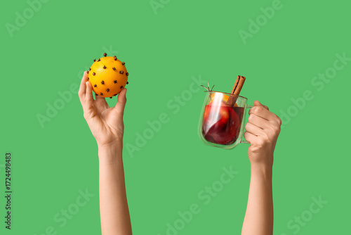 Female hands holding orange...